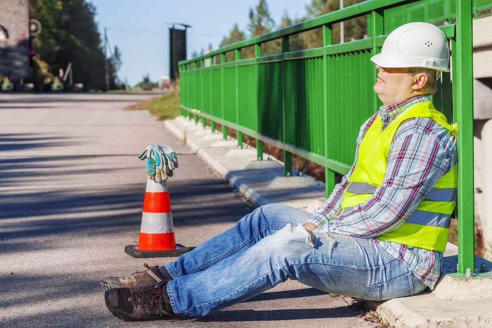 construction worker tired from ordering materials